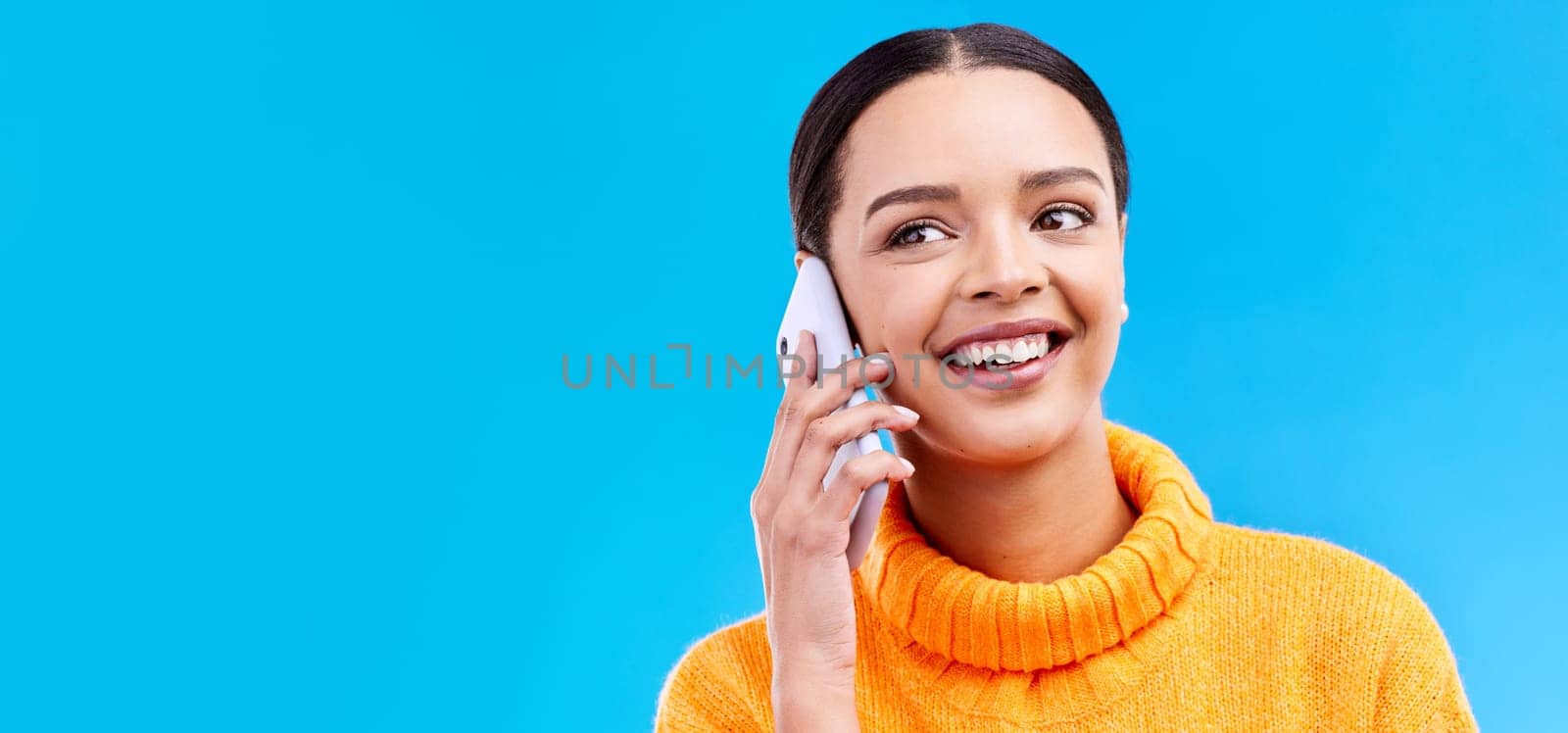 Happy woman, phone call and communication on mockup for social media, conversation or chat against a blue studio background. Female smiling on mobile smartphone in discussion or talking on copy space.