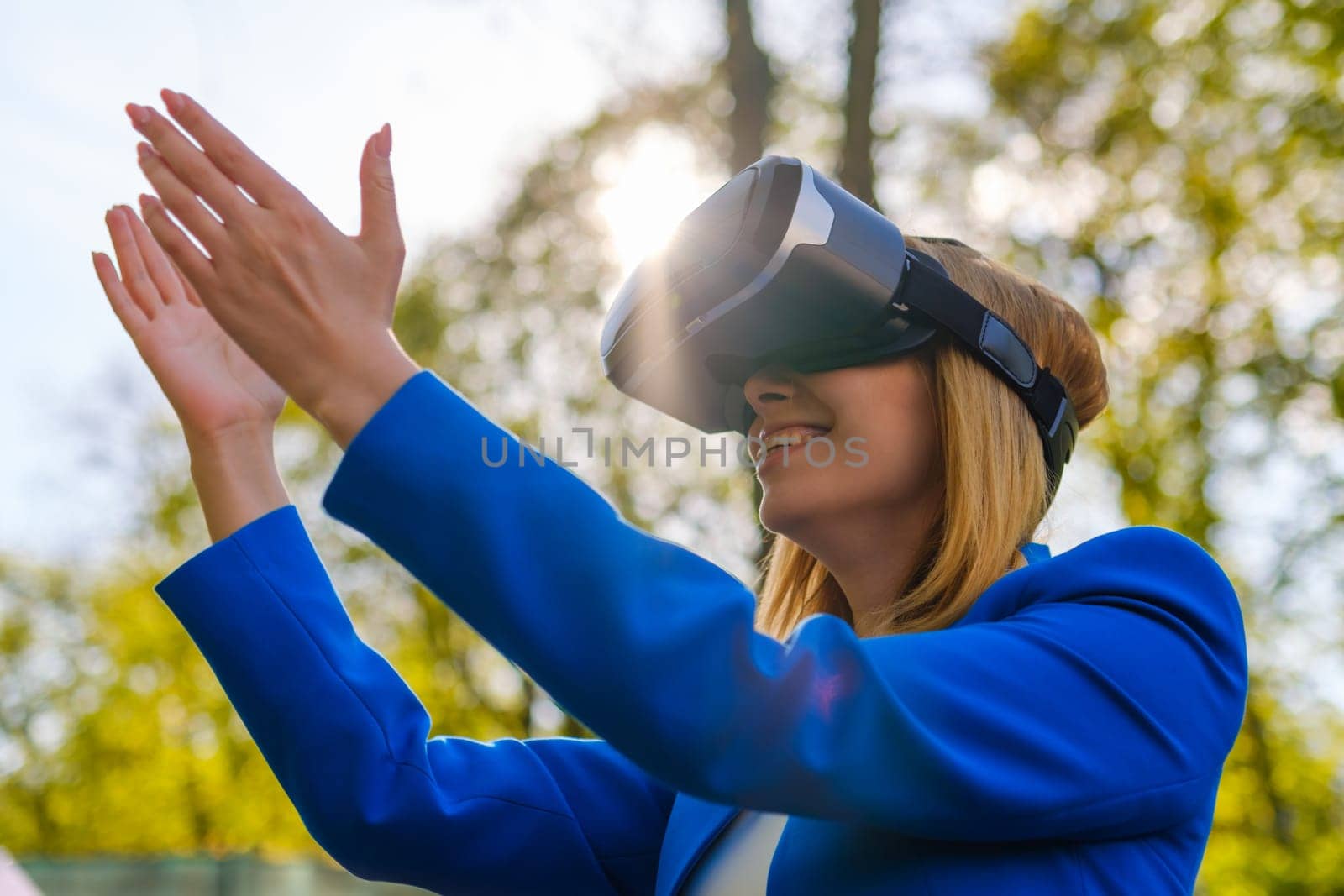 Girl stretched her hands to the sky in glasses of virtual reality.