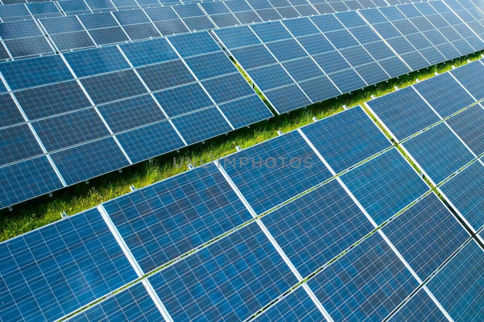 Solar panels in the green field for generation of green energy safety for environmental