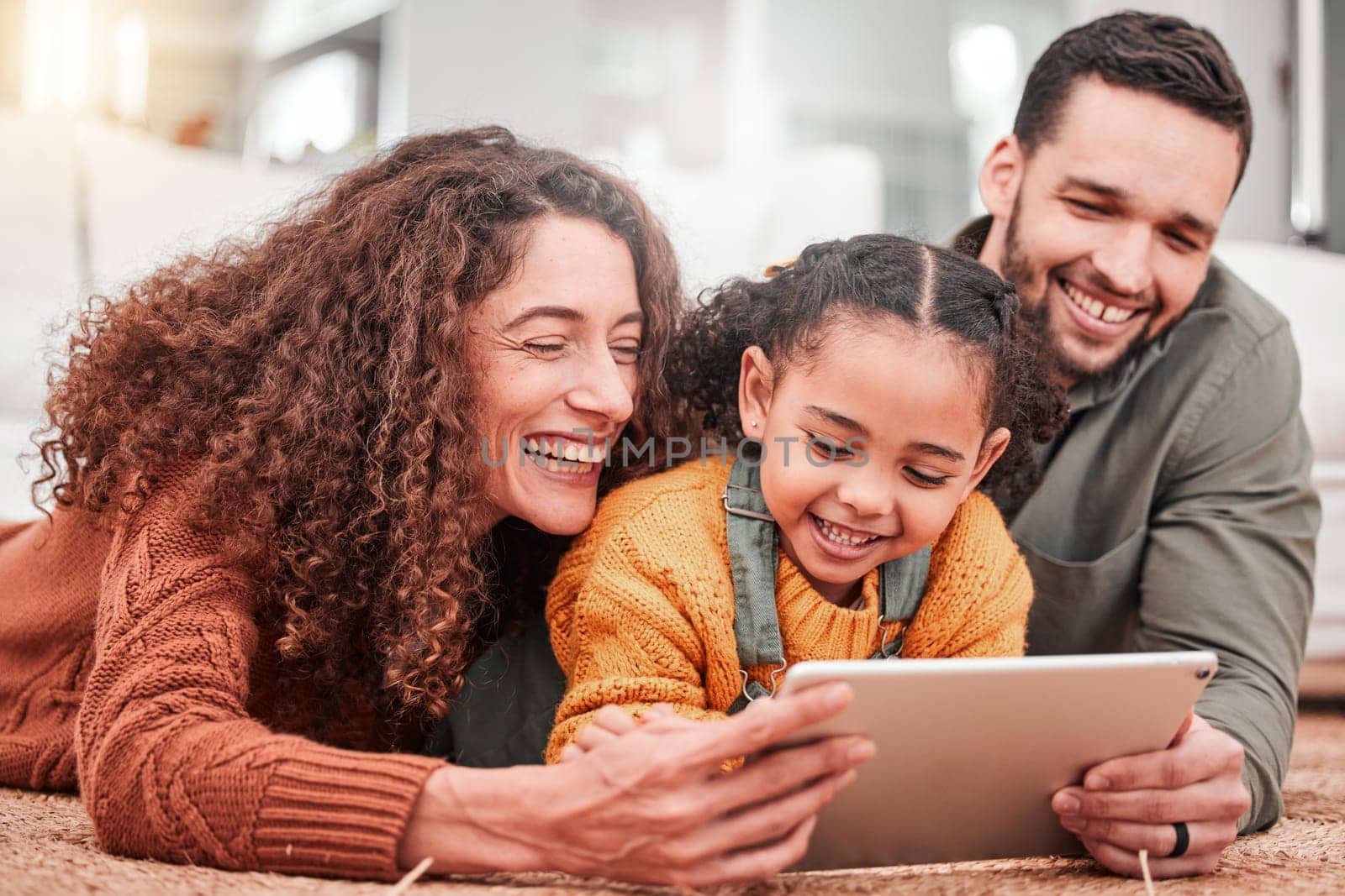 Happy family on floor with tablet, kid and movies, streaming service for child development video for education. Mom, dad and girl on carpet, happiness and smile, digital entertainment in living room