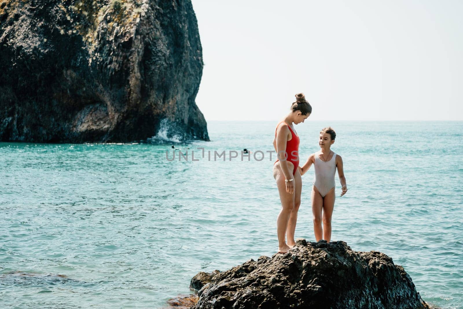 Silhouette mother and daughter doing yoga at beach. Woman on yoga mat in beach meditation, mental health training or mind wellness by ocean, sea