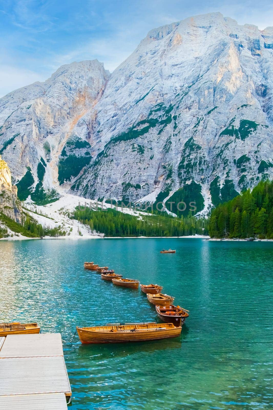 The magnificent Lake Braies with the chain of wooden boats in Dolomites Alps, Italy by vladimka