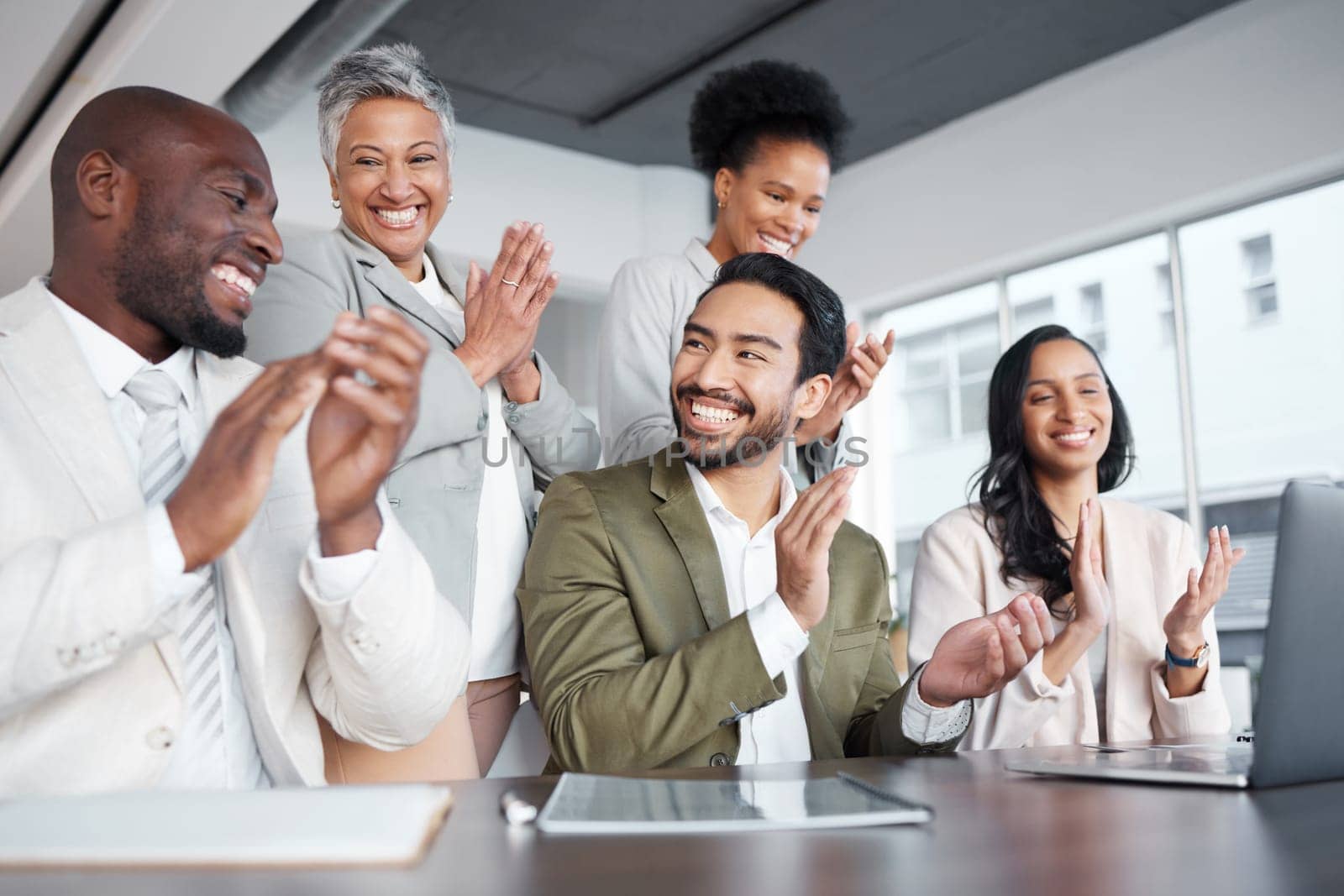 Business people, laptop and clapping hands in meeting for proposal, logo or reveal in office. Team, applause and corporate success by group celebrating achievement, project and job well done together.