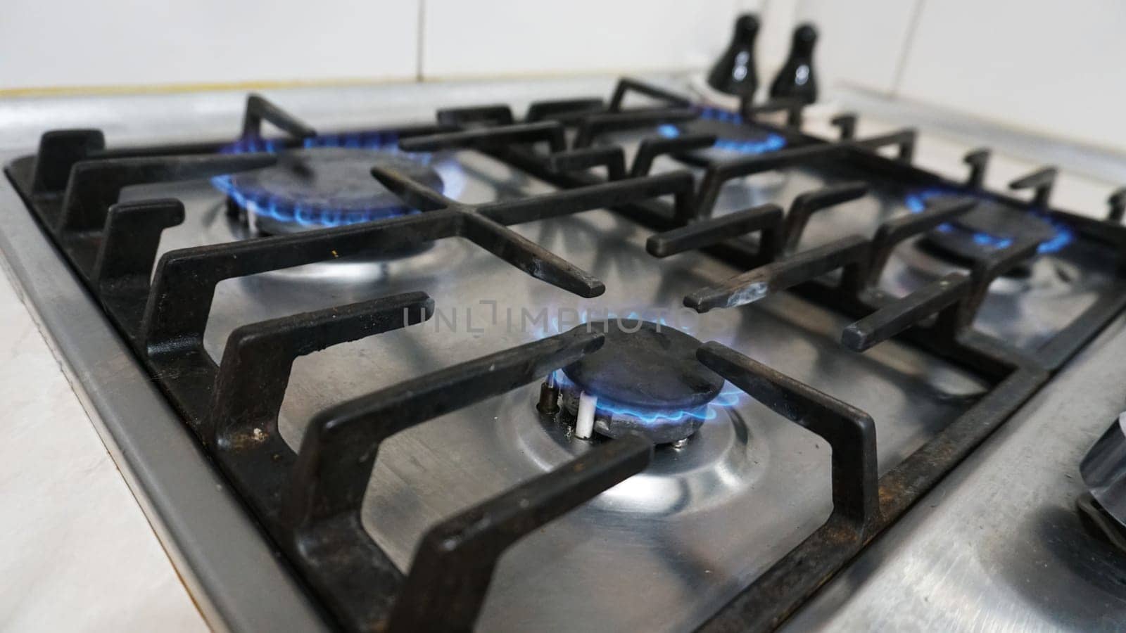 A blue fire is burning on gas stove. Gas at home by Passcal