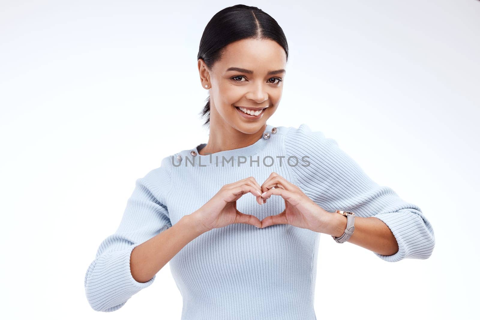Portrait, heart and hand gesture with a woman on a white background isolated in studio for health or love. Face, hands and emoji with an attractive young female indoor for romance or valentines day by YuriArcurs