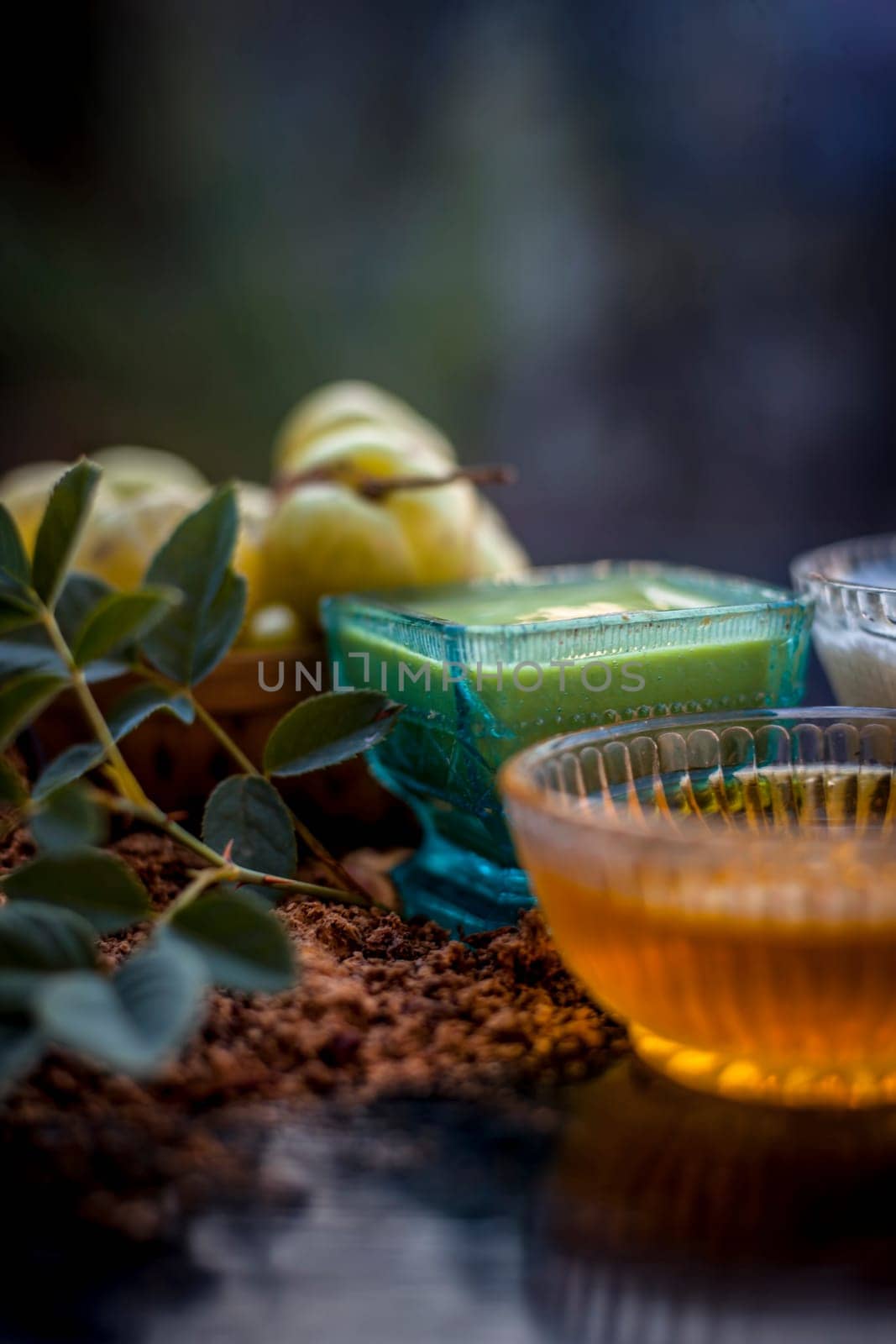 Close-up of herbal face pack of Indian gooseberry or amla with curd or yogurt and honey in a glass bowl on the wooden surface used to have instant bright skin. by mirzamlk
