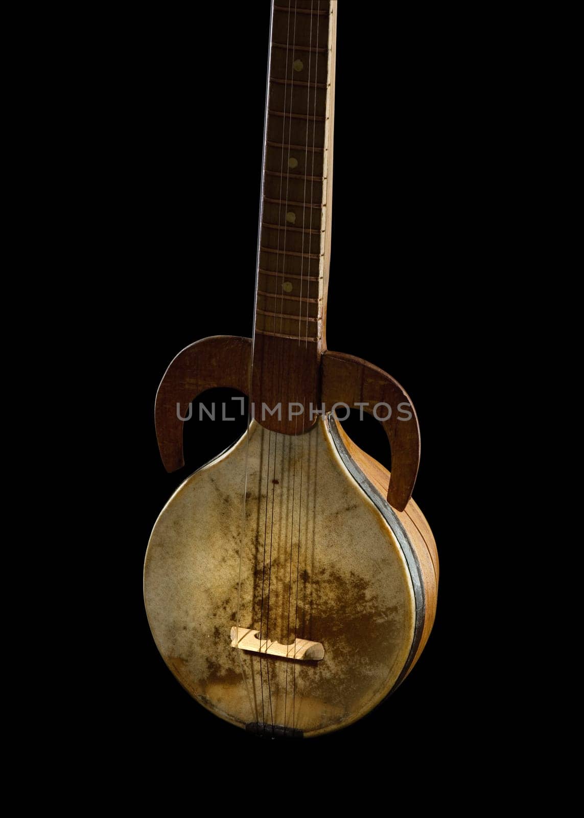 An ancient Asian stringed musical instrument on a black background
