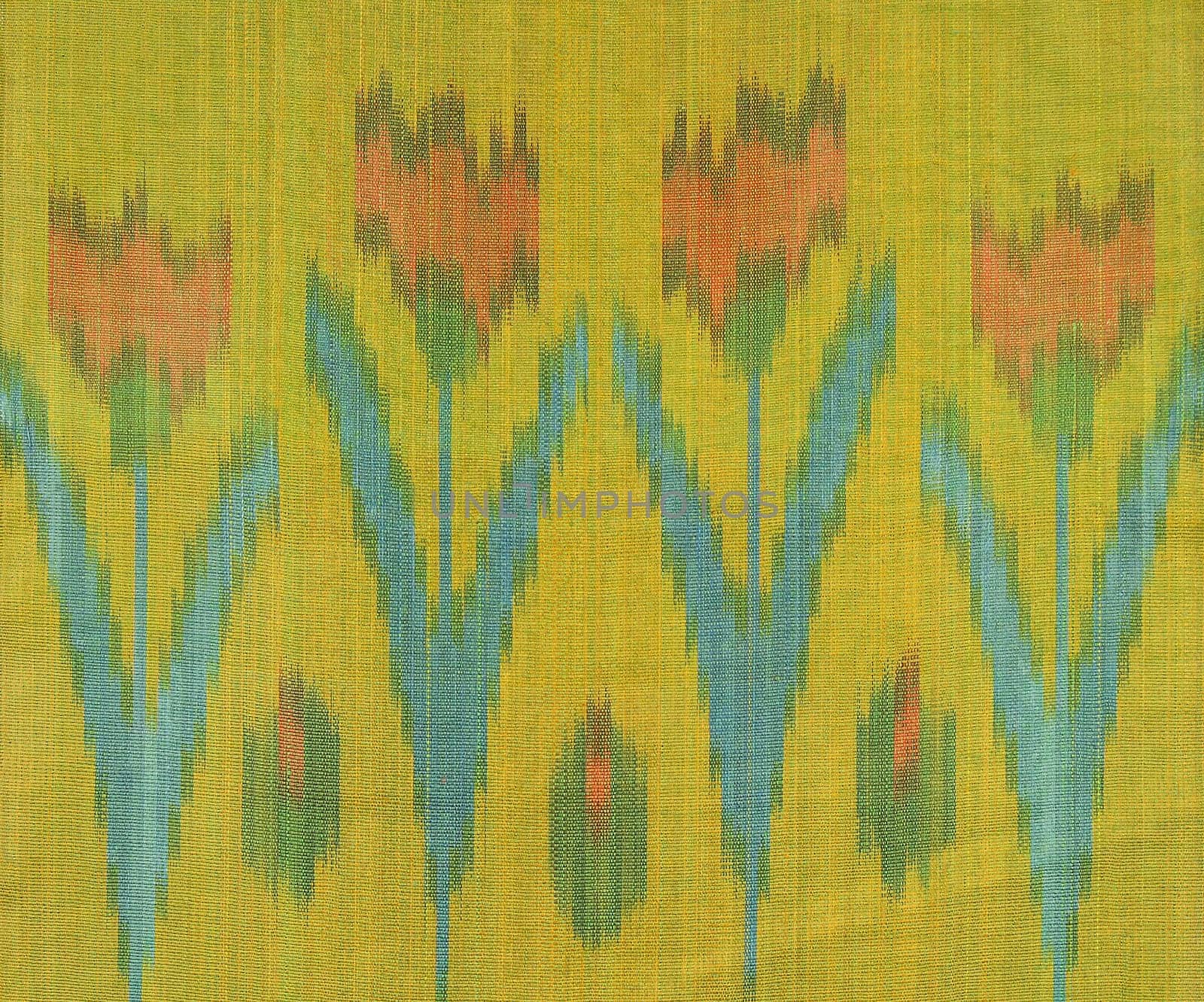 A design of red tulip flowers with green leaves on a yellow fabric