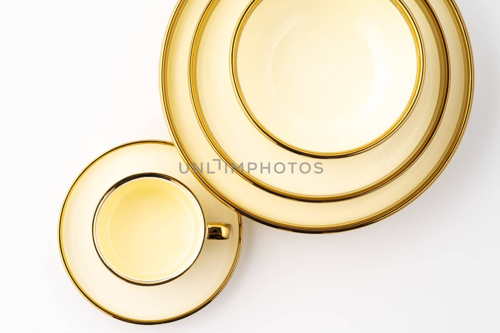 A set of golden luxury ceramic kitchen utensils on a white background