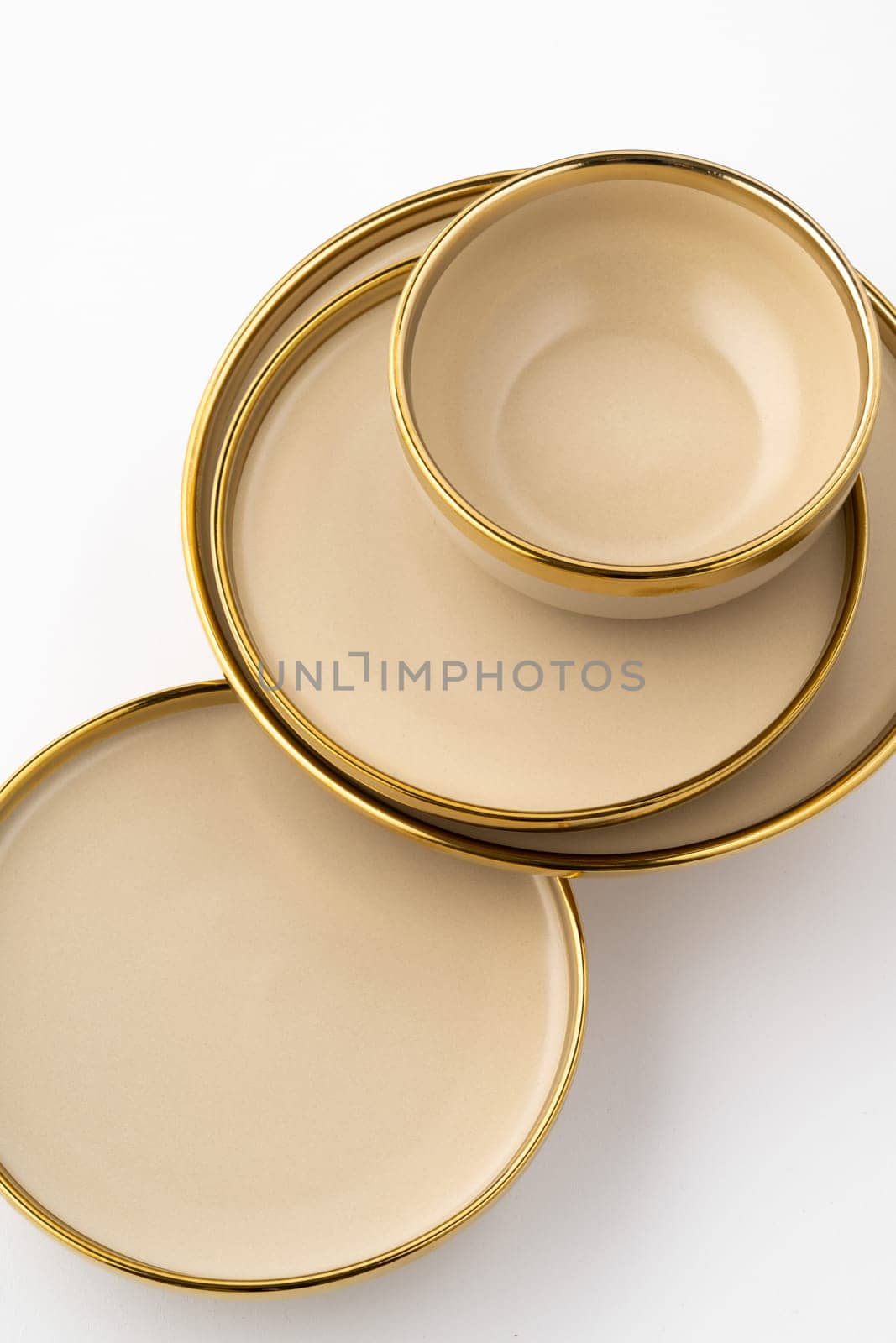A set of light brown ceramic plate and bowl on a white background. Top view by A_Karim