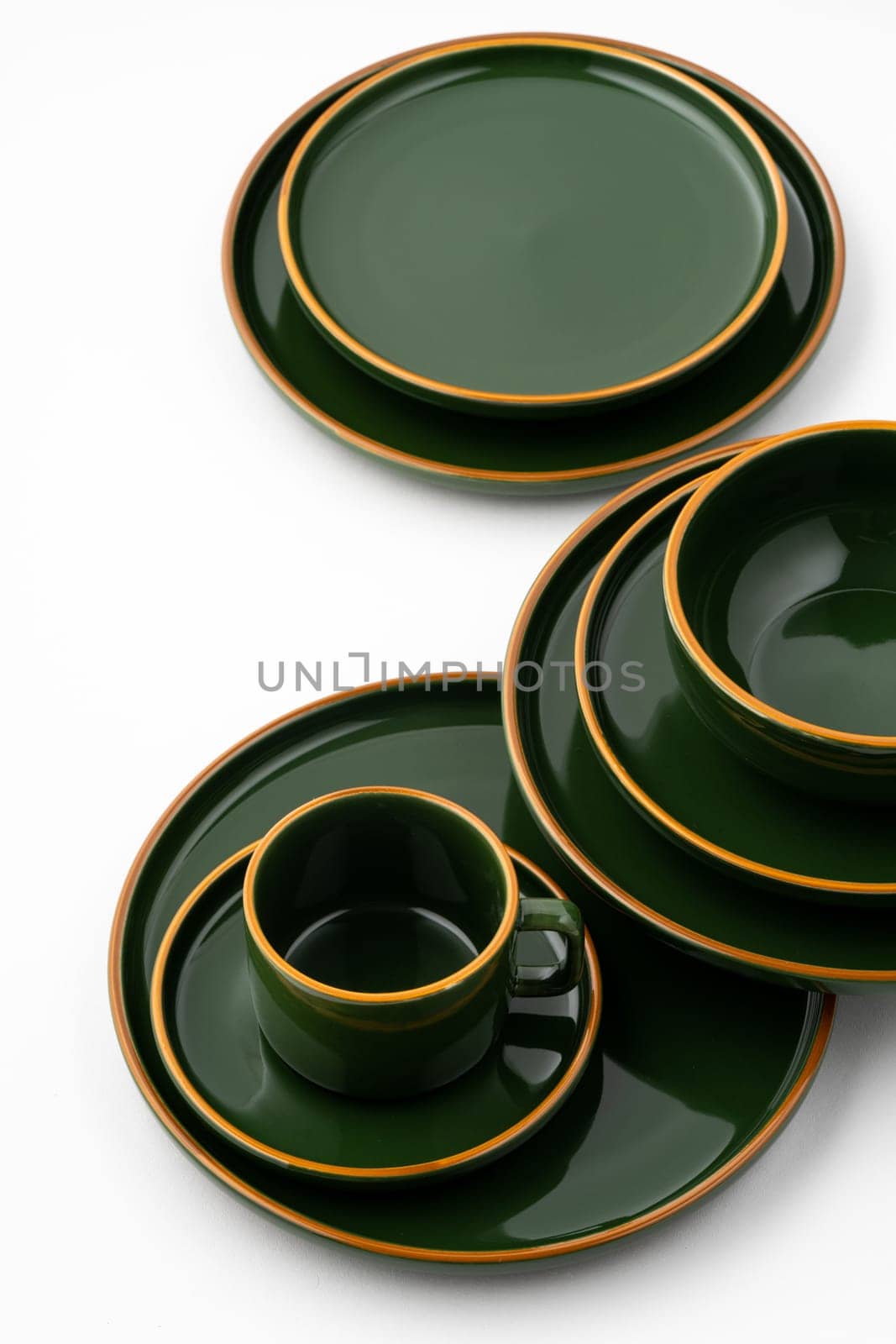 A set of dark green ceramic tableware with orange outlines on a white background by A_Karim