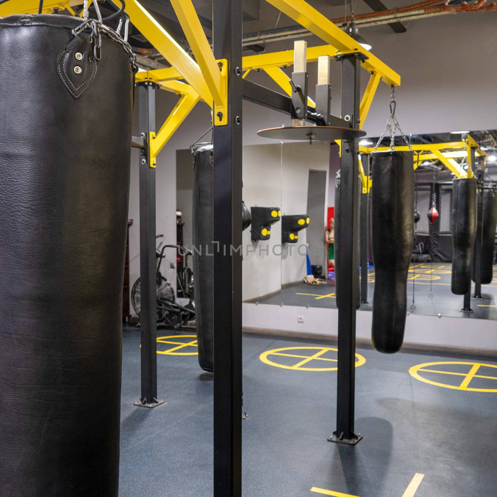 A vertical shot of boxing bags in the sports complex by A_Karim