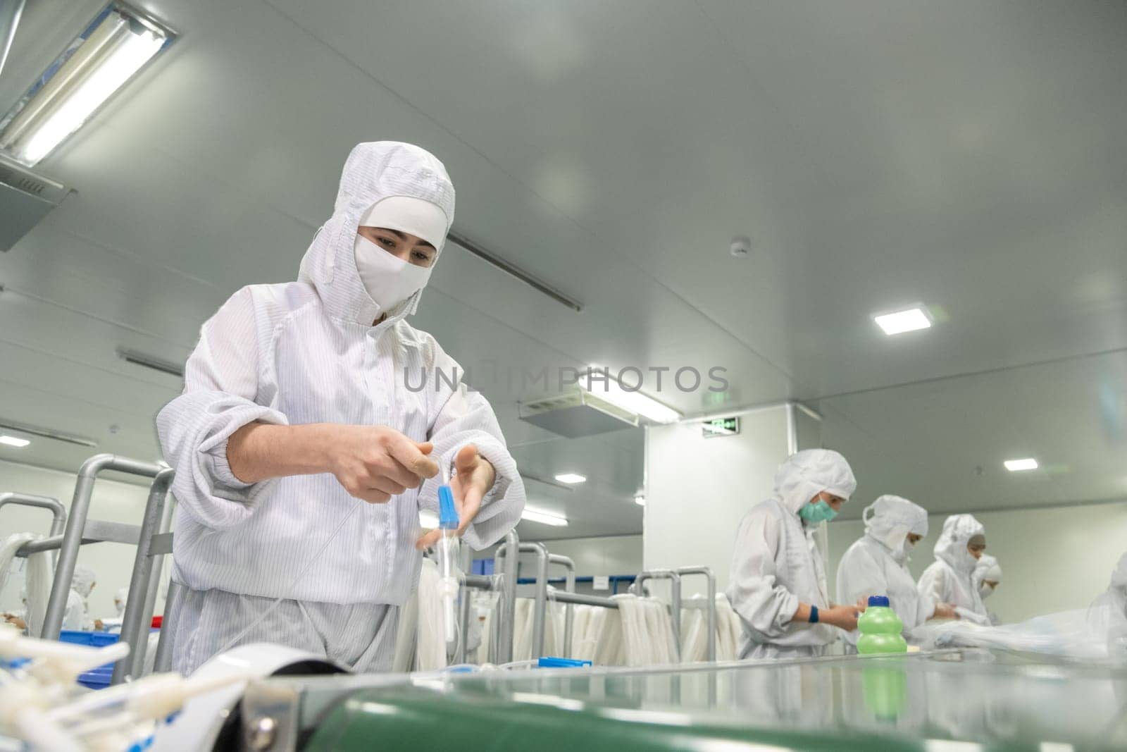 The workers in the workshop for the production of medical syringes and droppers by A_Karim