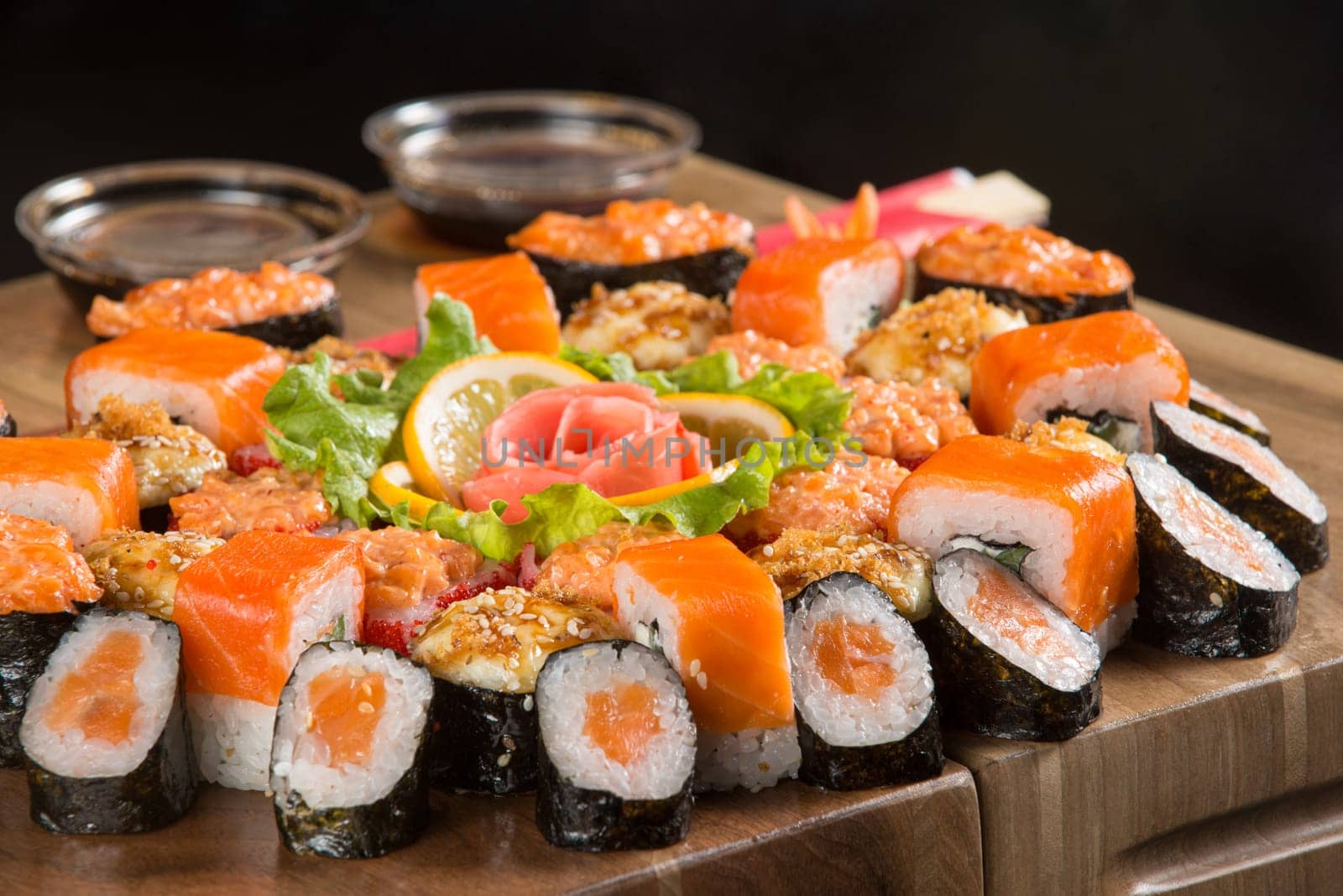 A closeup shot of a sushi set on a wooden plate