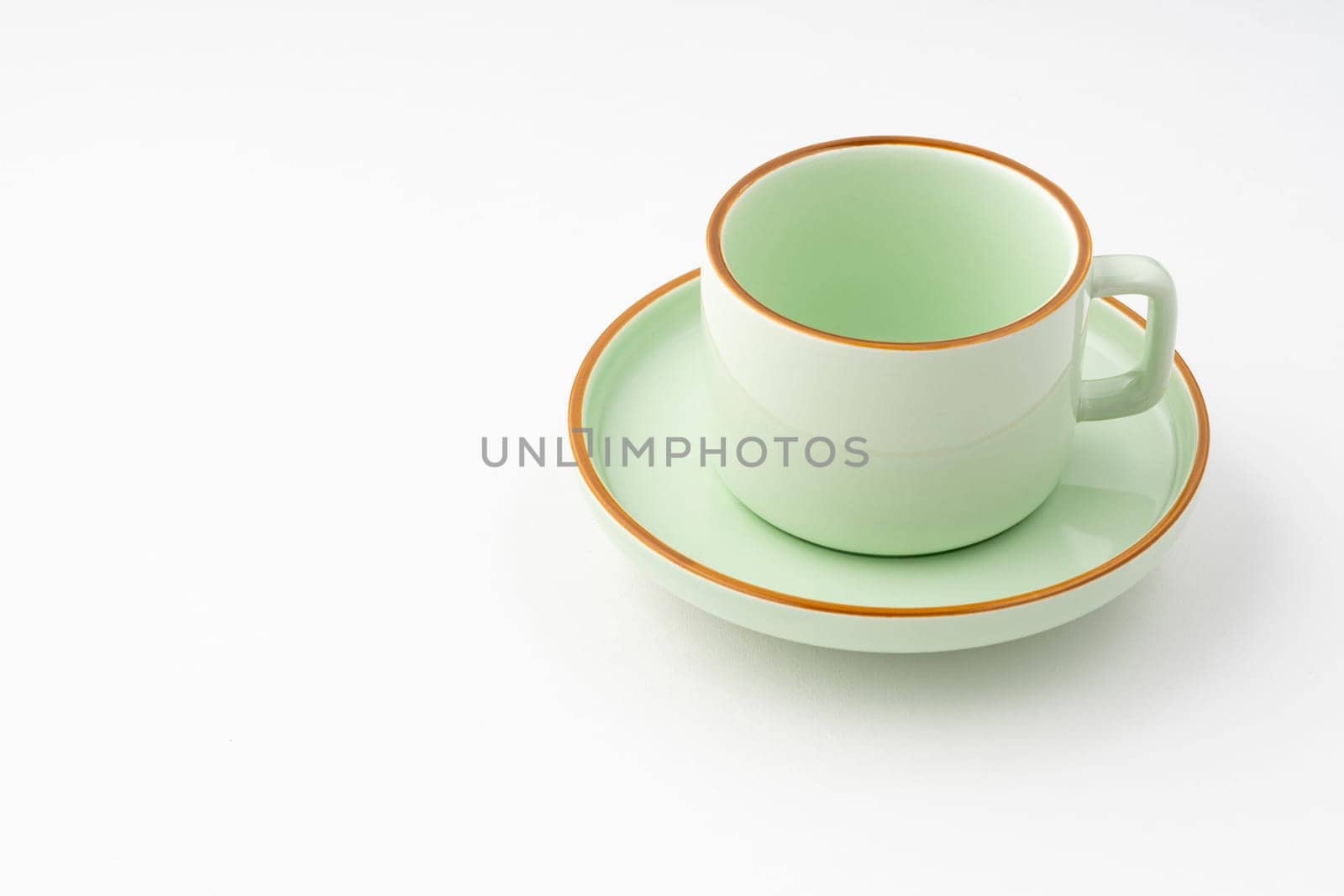 A green ceramic tea cup isolated on white background