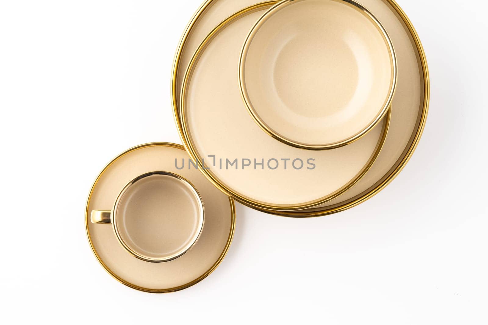 A Set of light brown ceramic plate and cup on a white background. Top view