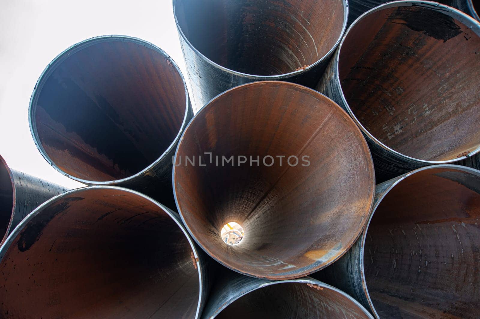 A line of oilfield large streel pipes, front view