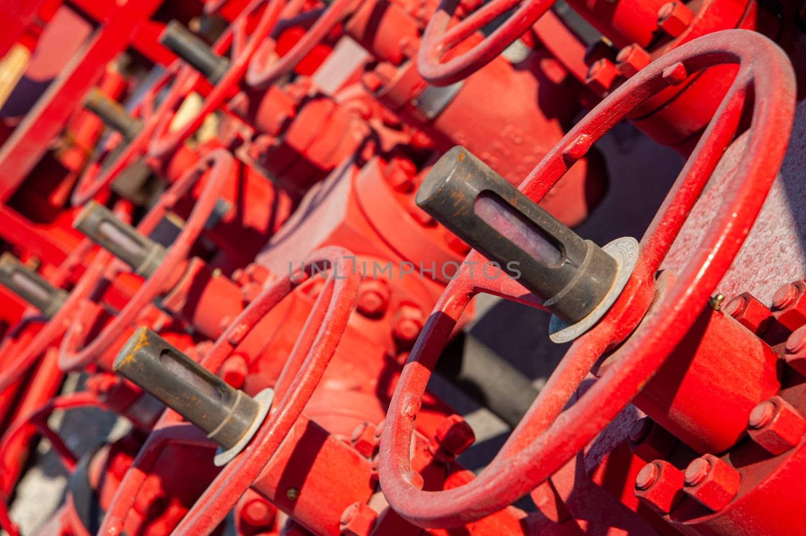 A closeup of a red industrial oil pipeline valves by A_Karim