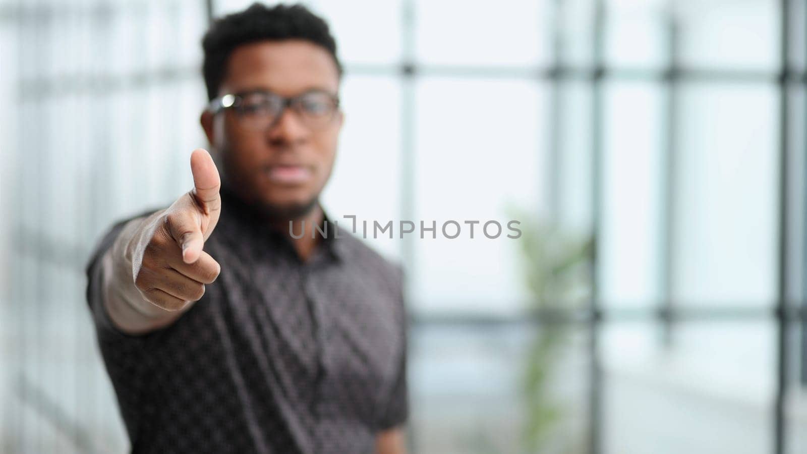 You won't get away with it. Portrait of a businessman pointing his finger to you