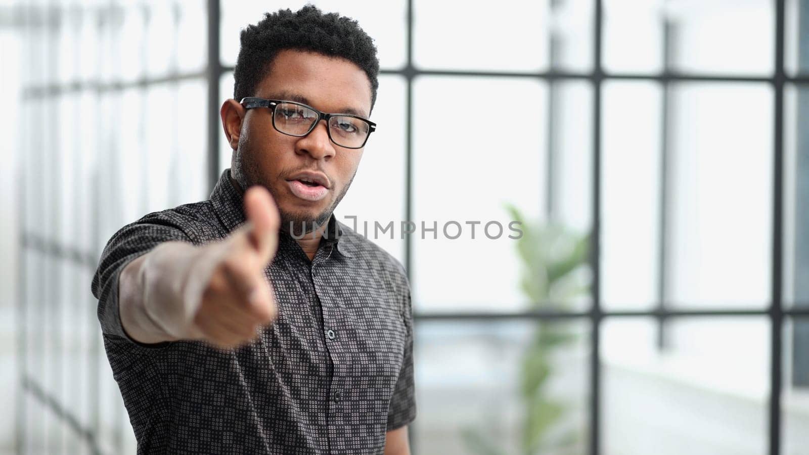 You won't get away with it. Portrait of a businessman pointing his finger to you