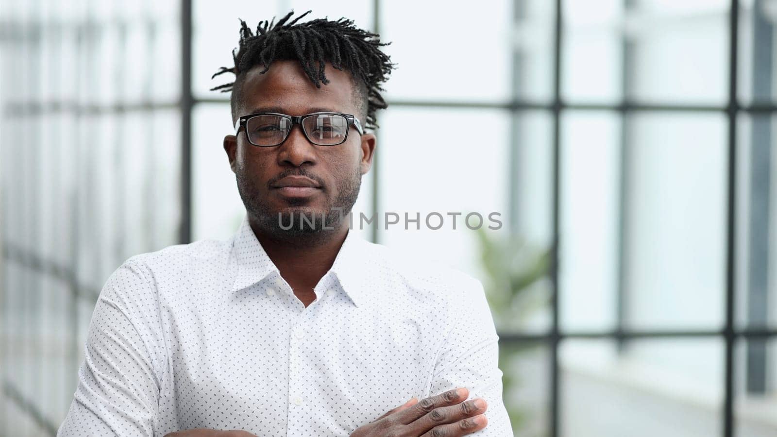 Portrait of a serious Black businessman with arms folded