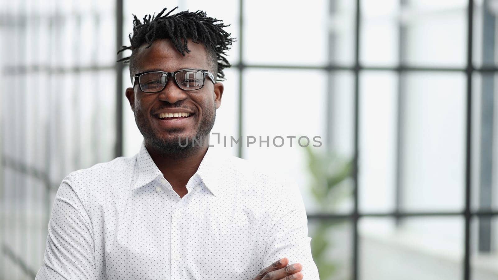 Portrait of a smiling businessman with arms crossed