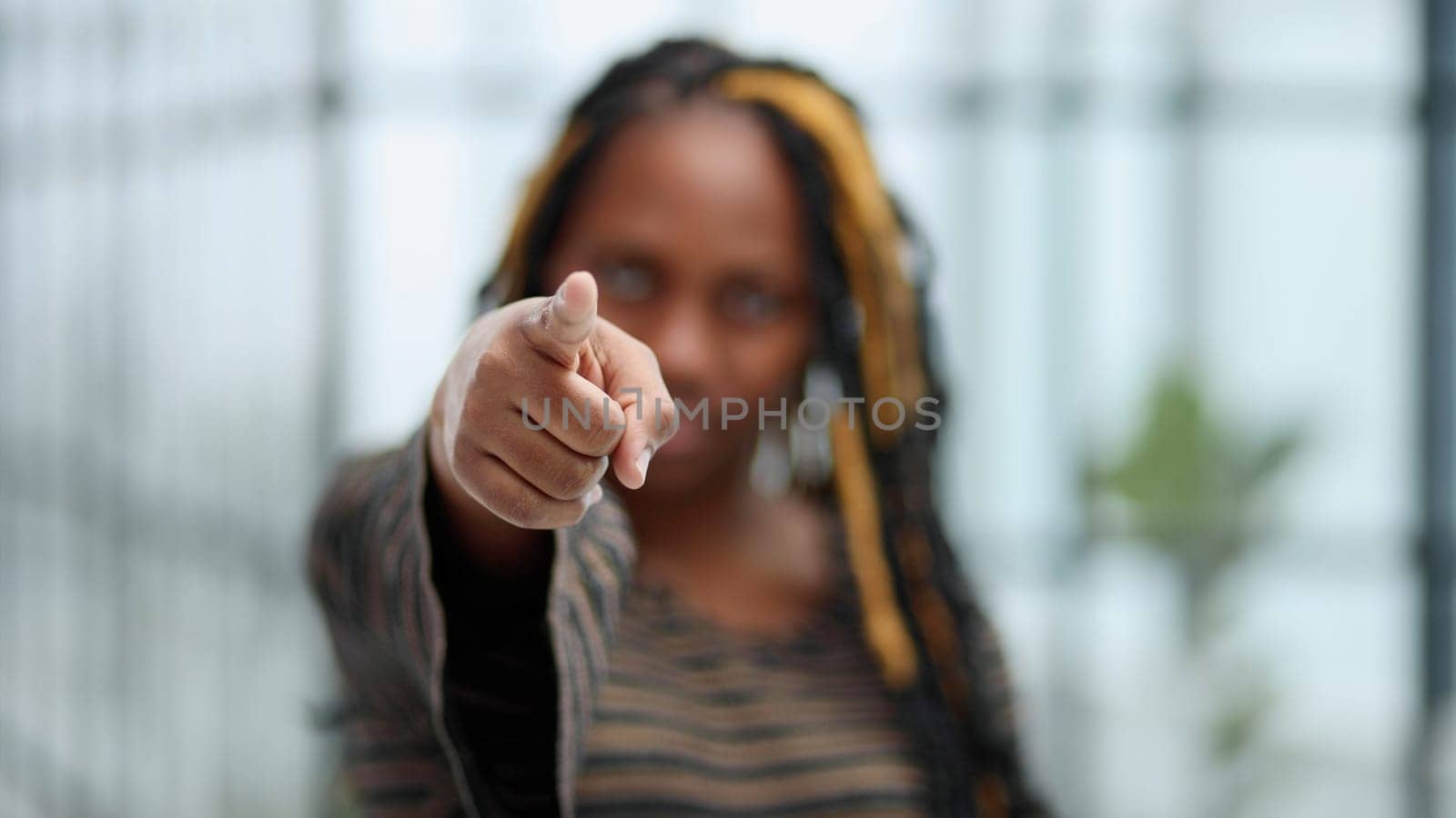 African young woman pointing finger at camera, close up