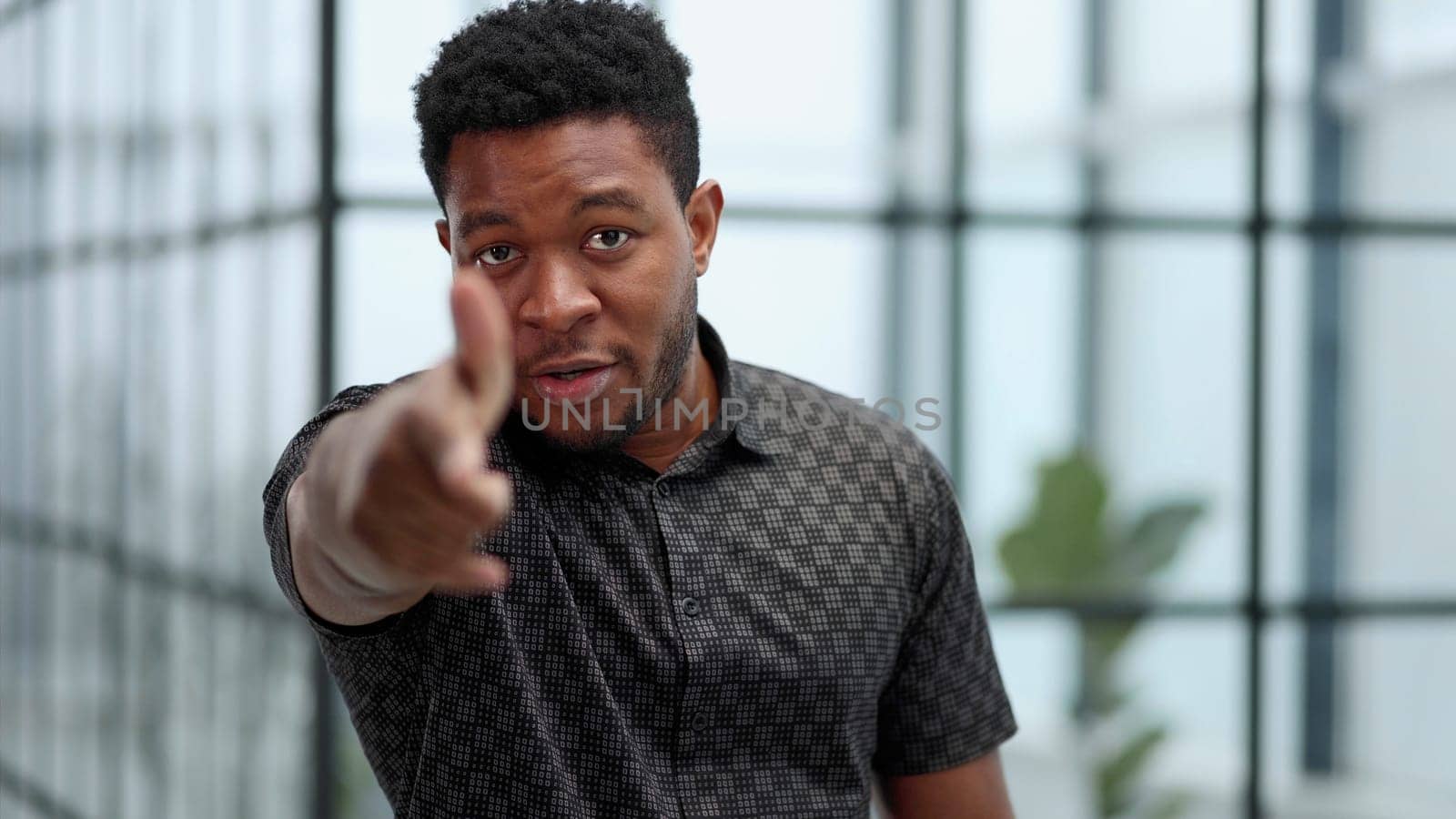 Indoor shot of a young confident black businessman looking serious