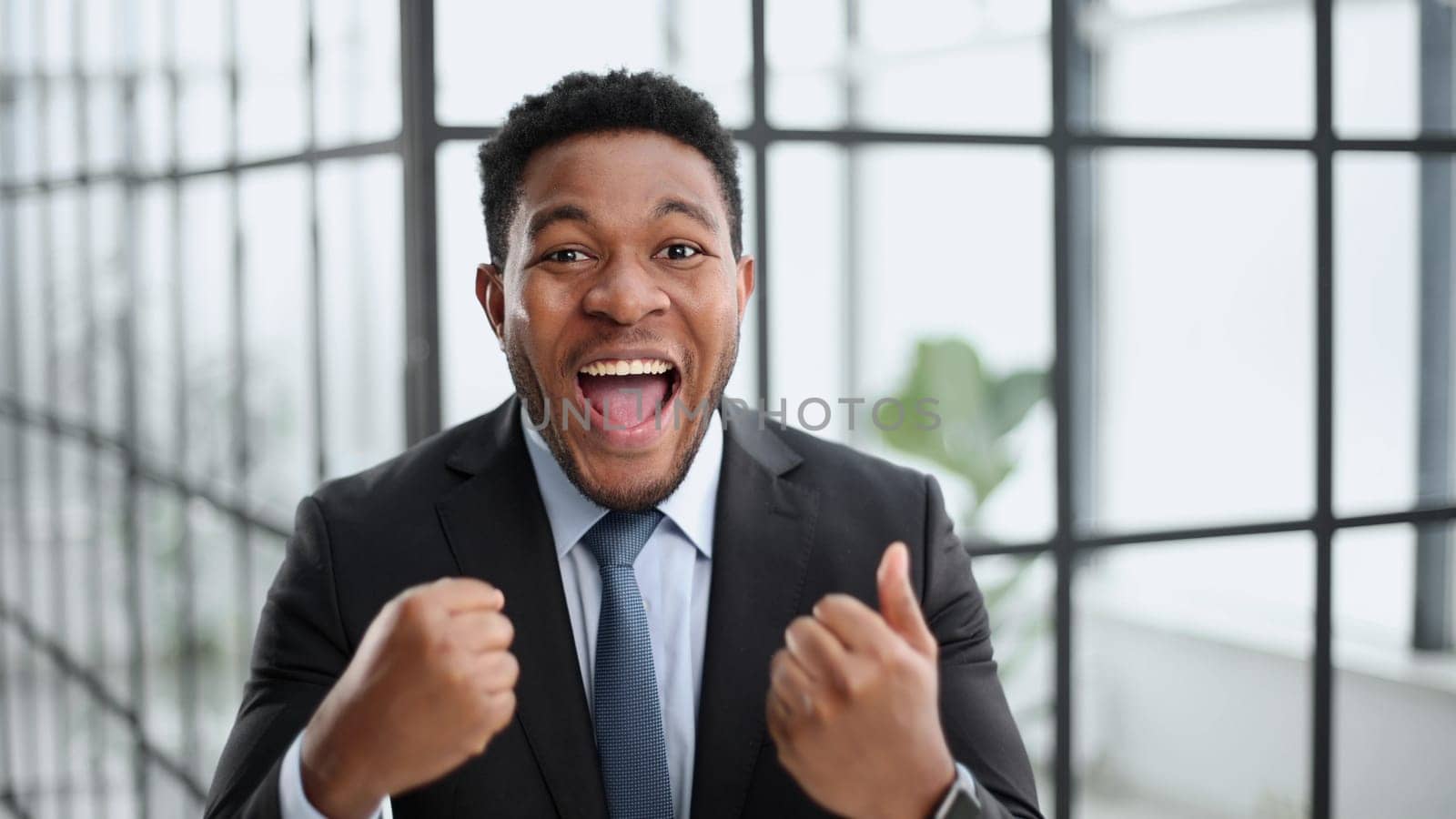 Photo of a young excited guy rejoicing in luck,
