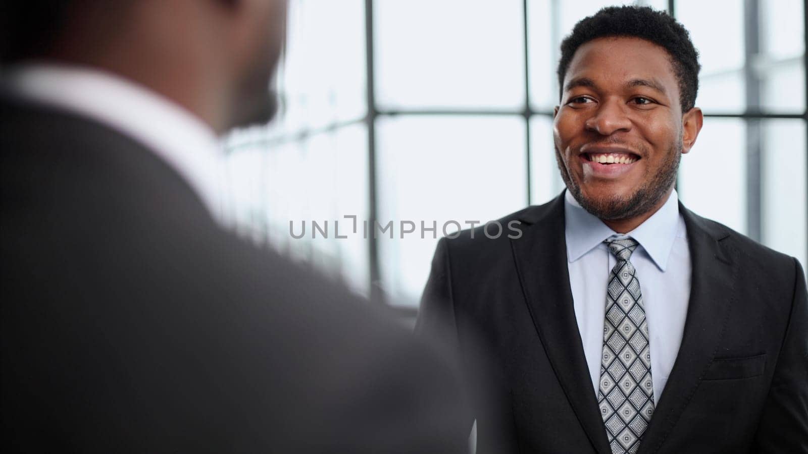 We understand the details. two businessmen talking in a modern office