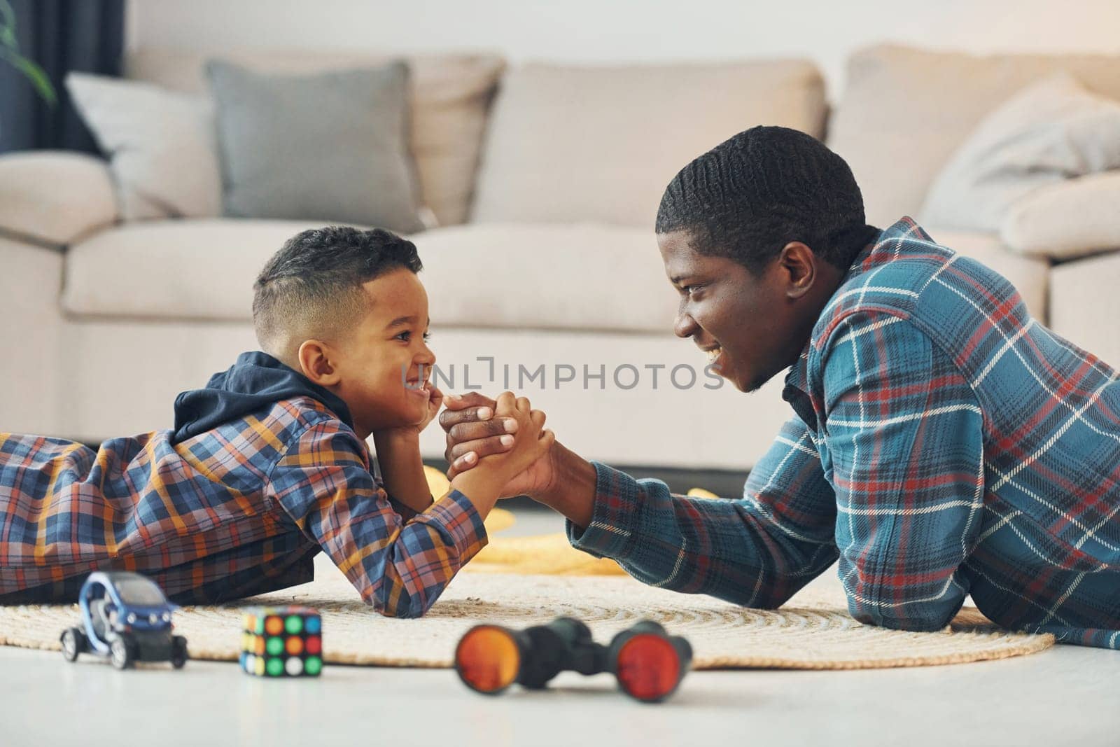 Side view. African american father with his young son at home by Standret