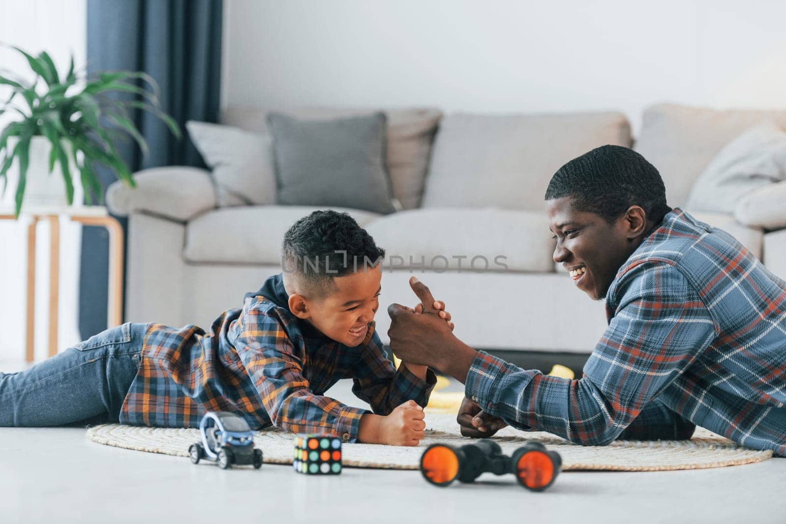 Side view. African american father with his young son at home by Standret