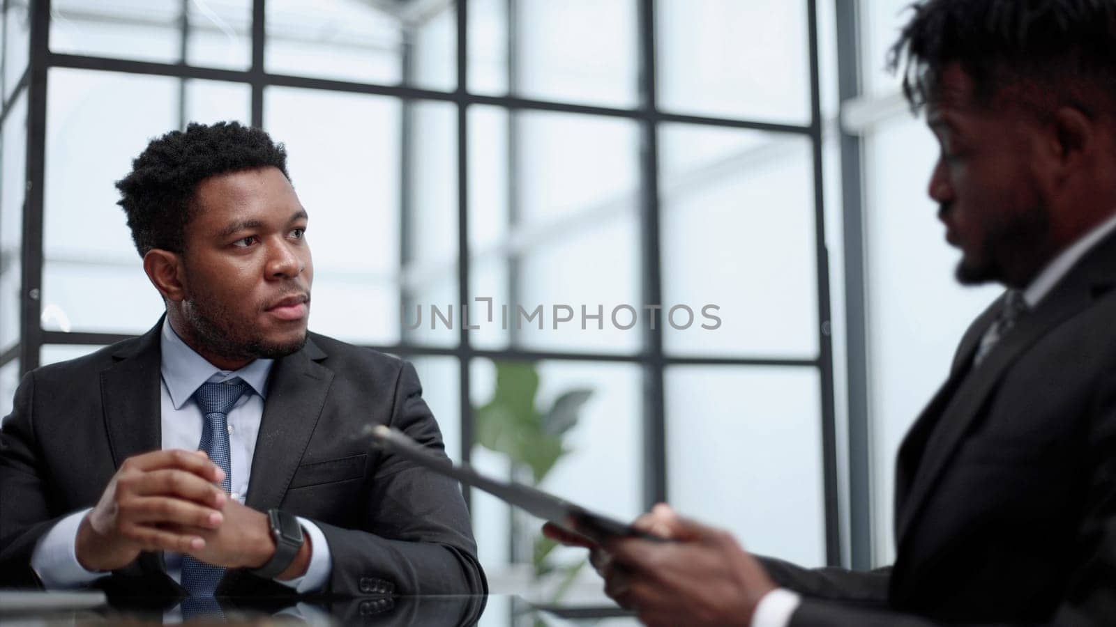 african american male business partners discussing a project in the office