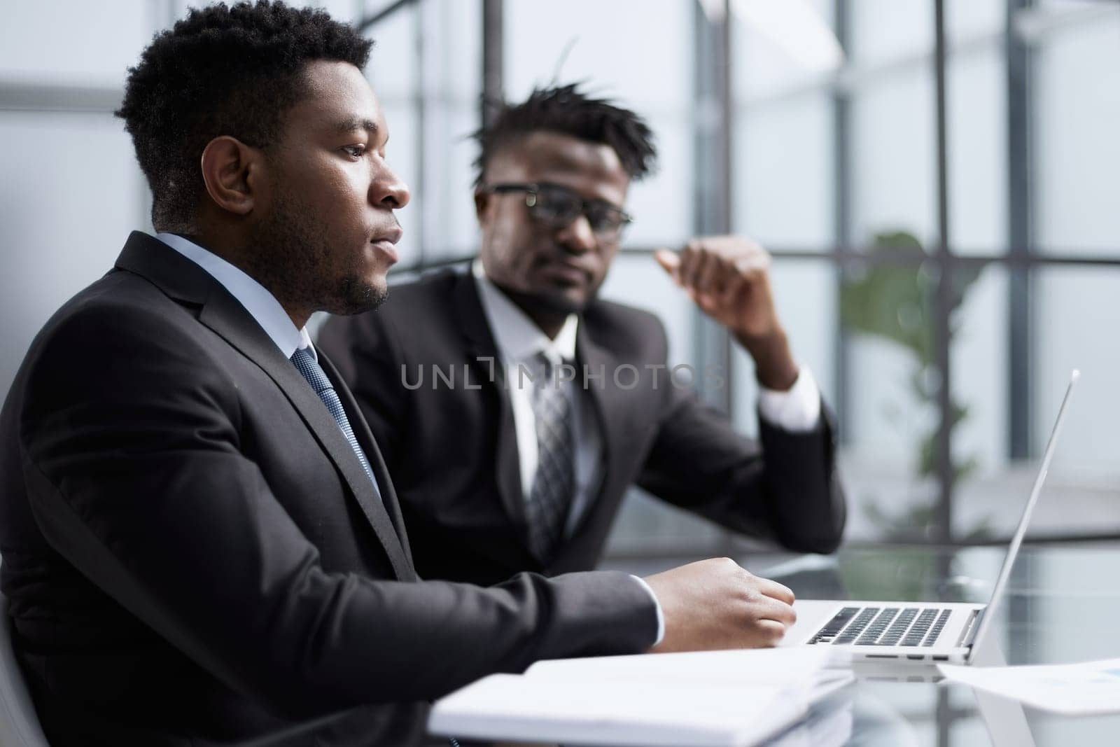 African american boss negotiating discussing contract details with company corporate client.