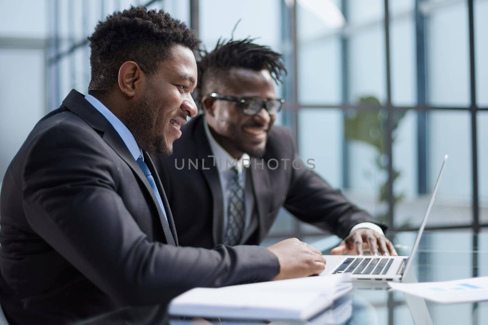 African american boss negotiating discussing contract details with company corporate client.