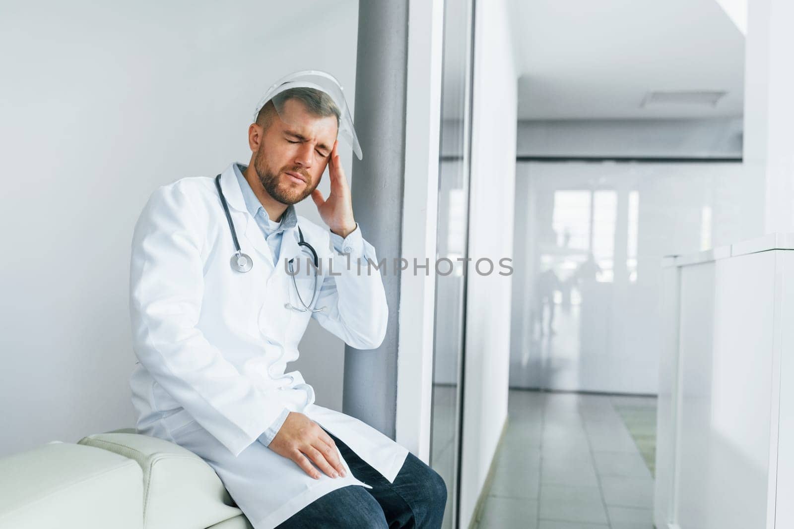 Feeling bad and tired. Professional medic in white coat is in the clinic.