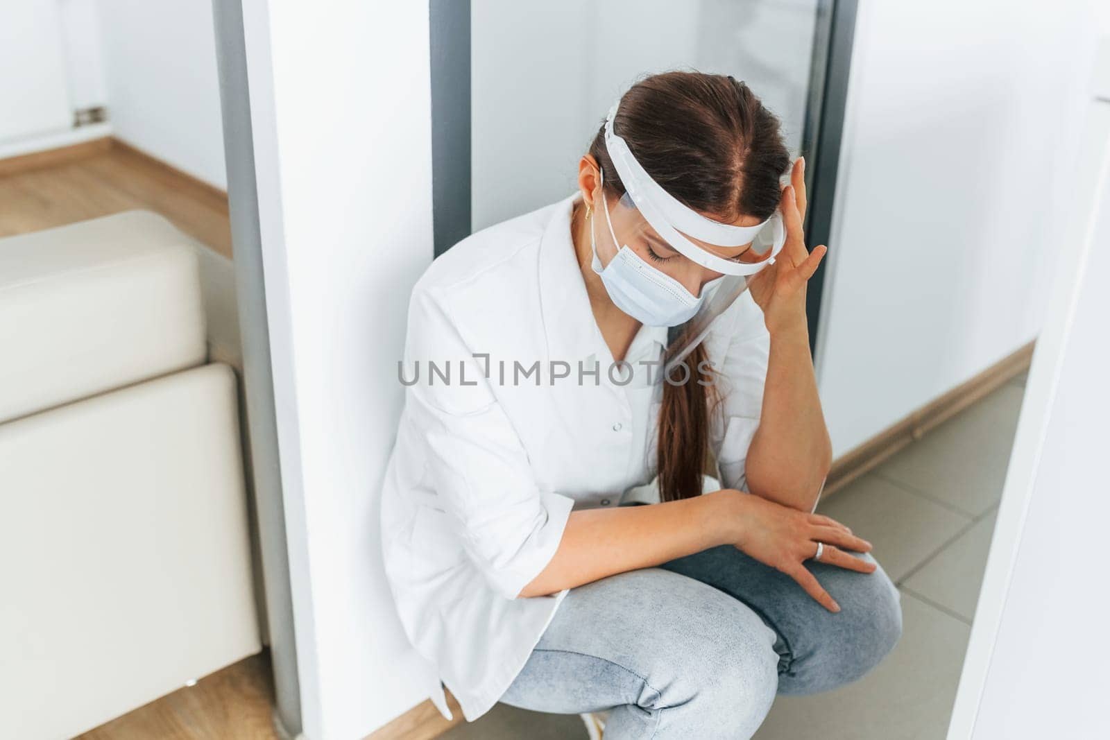 Feeling bad and tired. Professional medic in white coat is in the clinic.