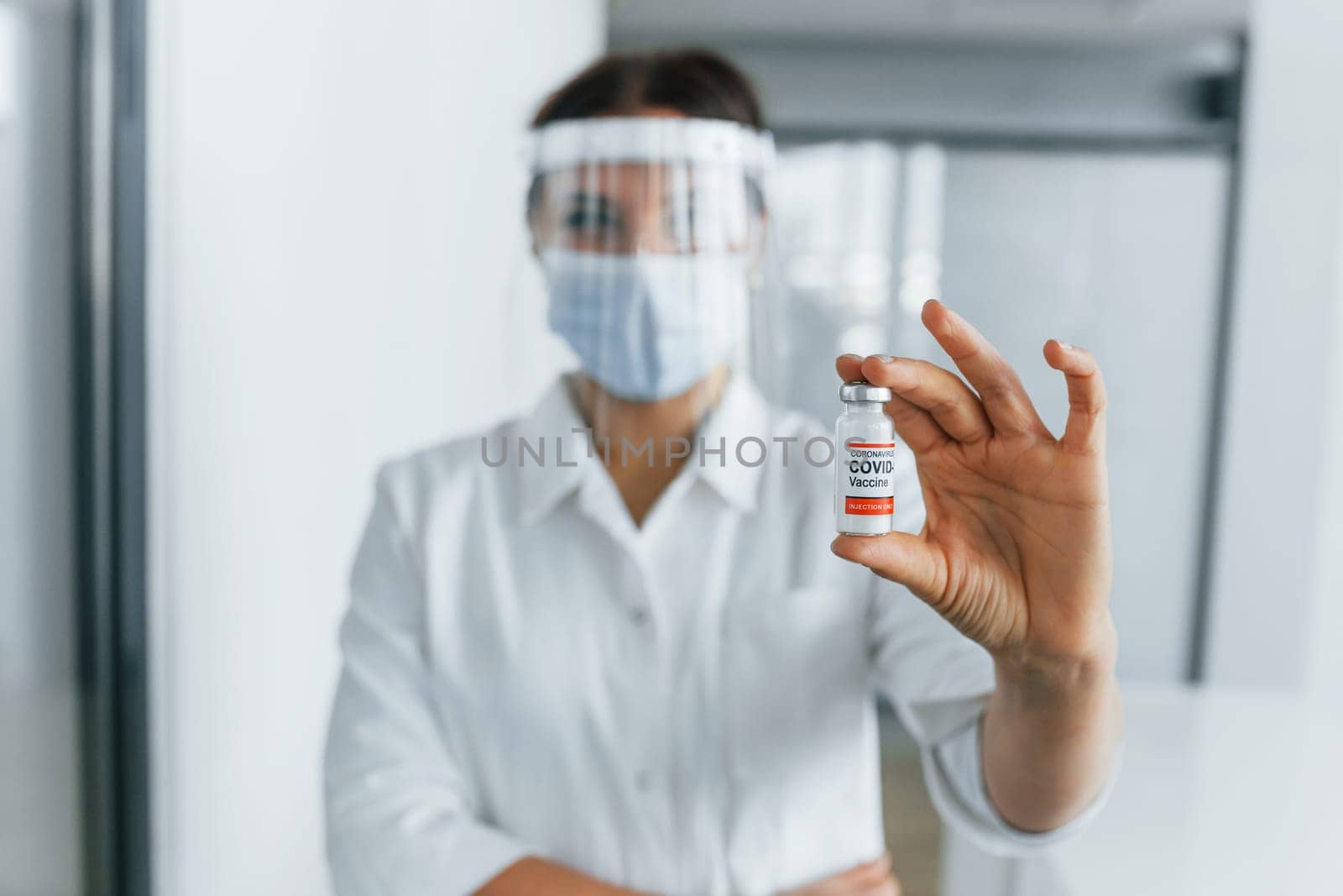 COVID-19 vaccine. Professional medic in white coat is in the clinic.