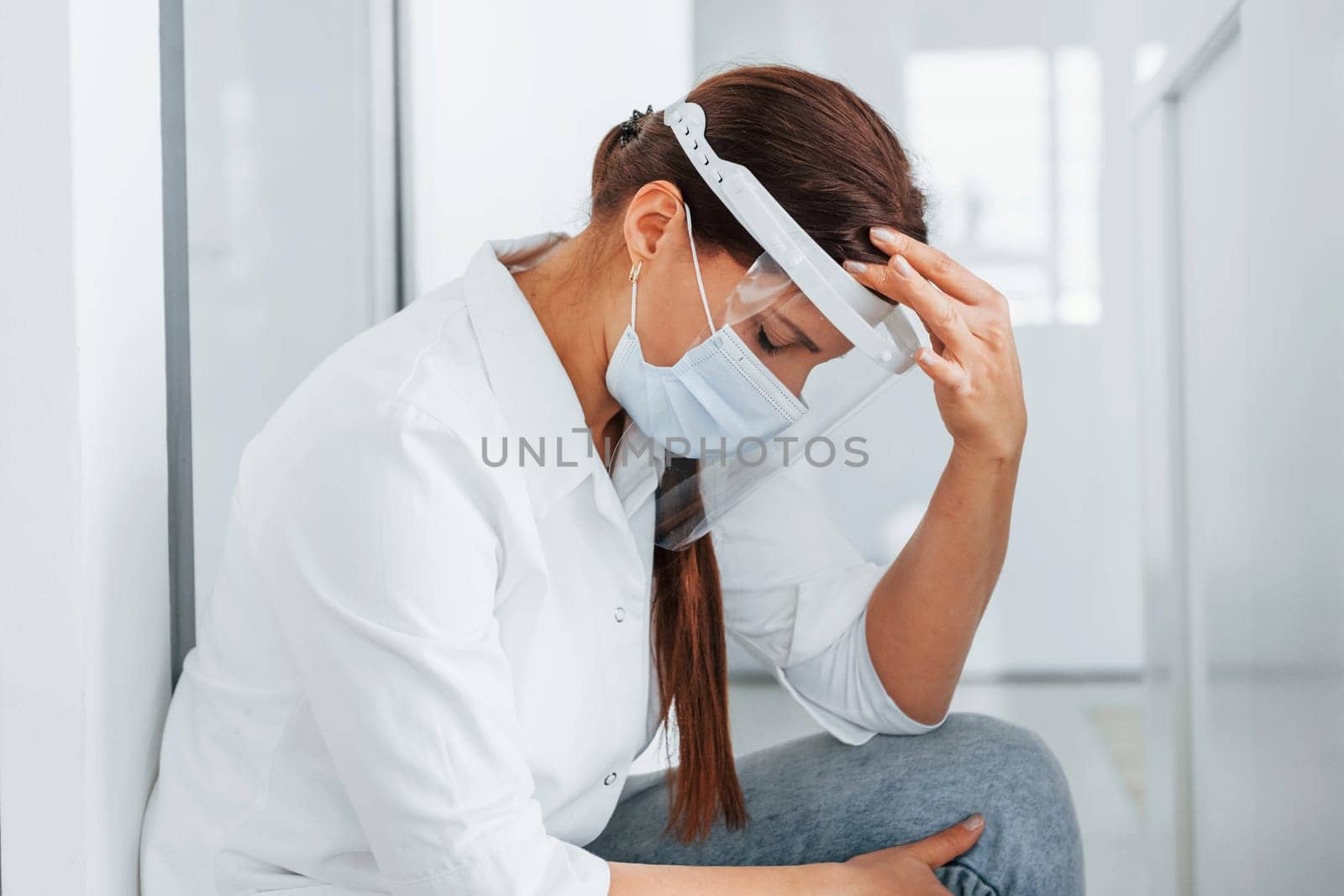 Sitting in the hospital. Professional medic in white coat is in the clinic.
