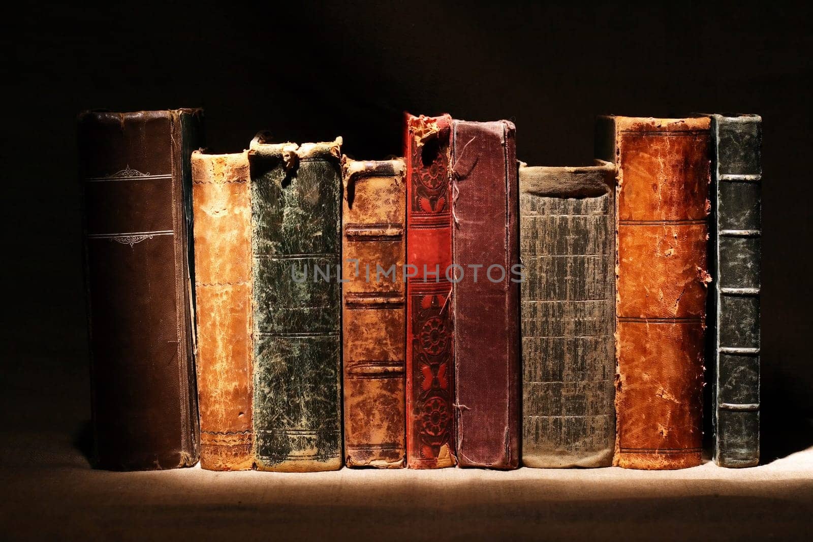 Set of various old books on dark background