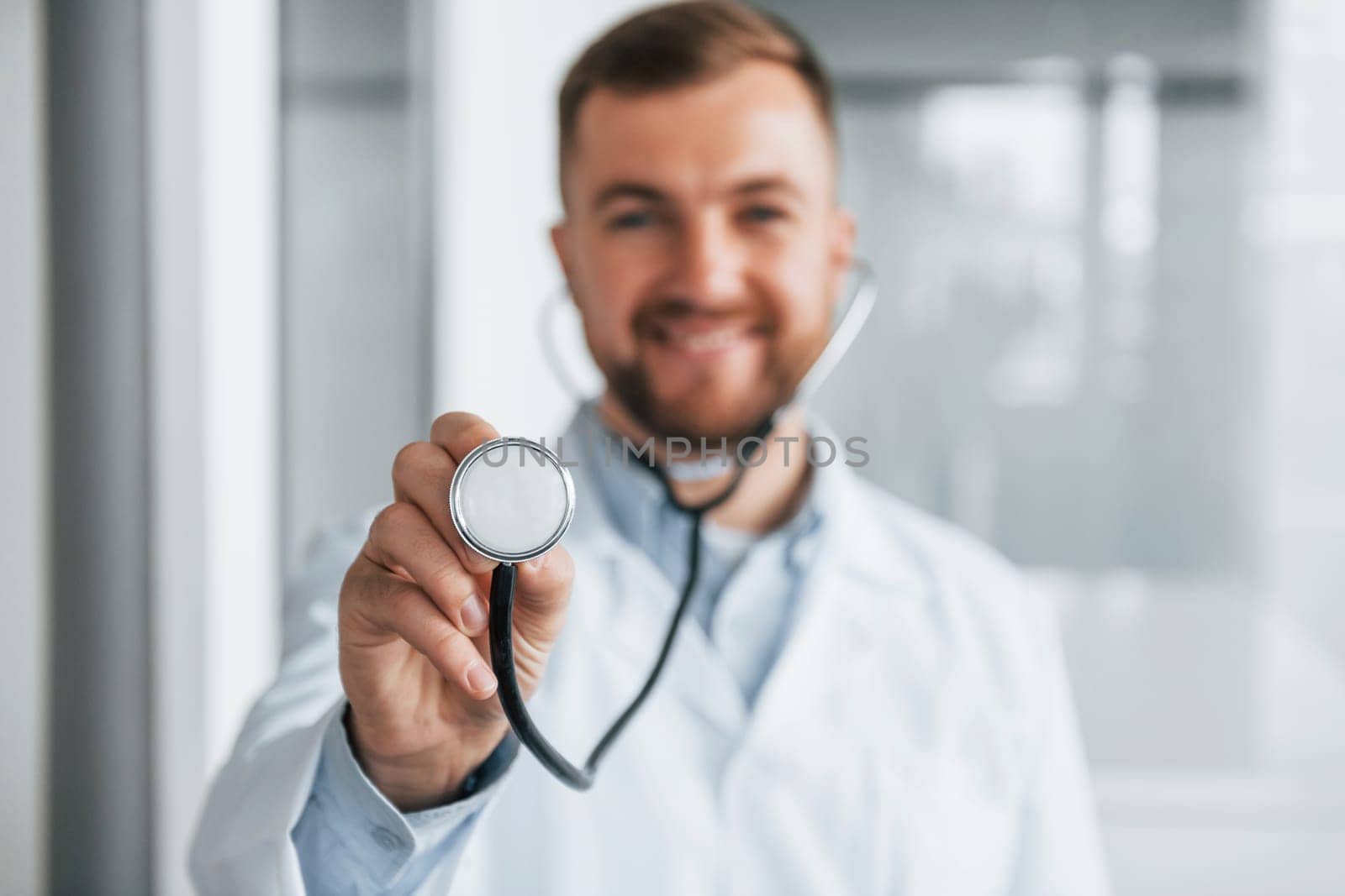 Focused image. Professional medic in white coat is in the clinic.
