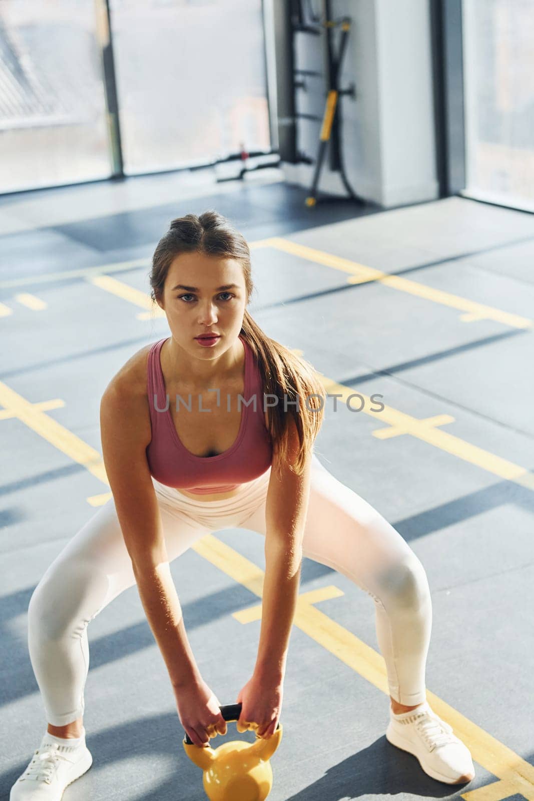 In the gym. Beautiful young woman with slim body type.