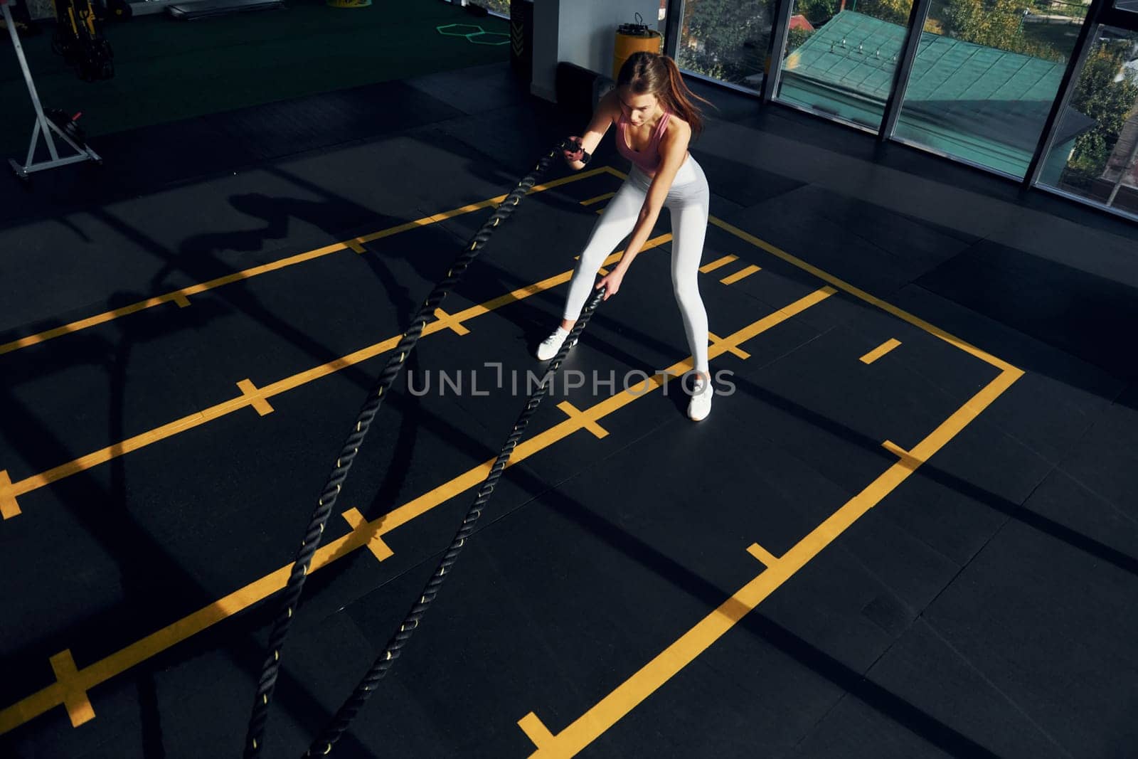 Active lifestyle. Beautiful young woman with slim body type is in the gym.