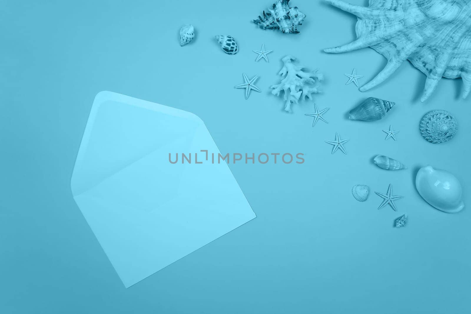 Blue background with envelope and shells and starfish