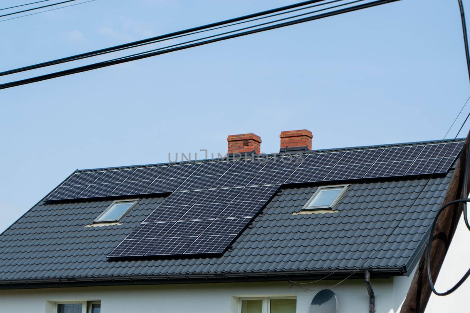 Historic farm house with modern solar panels on roof and wall High quality photo