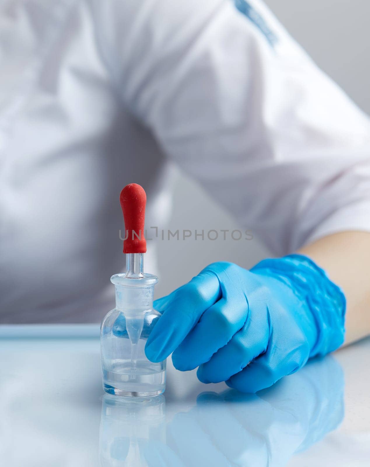 Doctor using pipette for taking samples for test in special chemical laboratory or private clinic