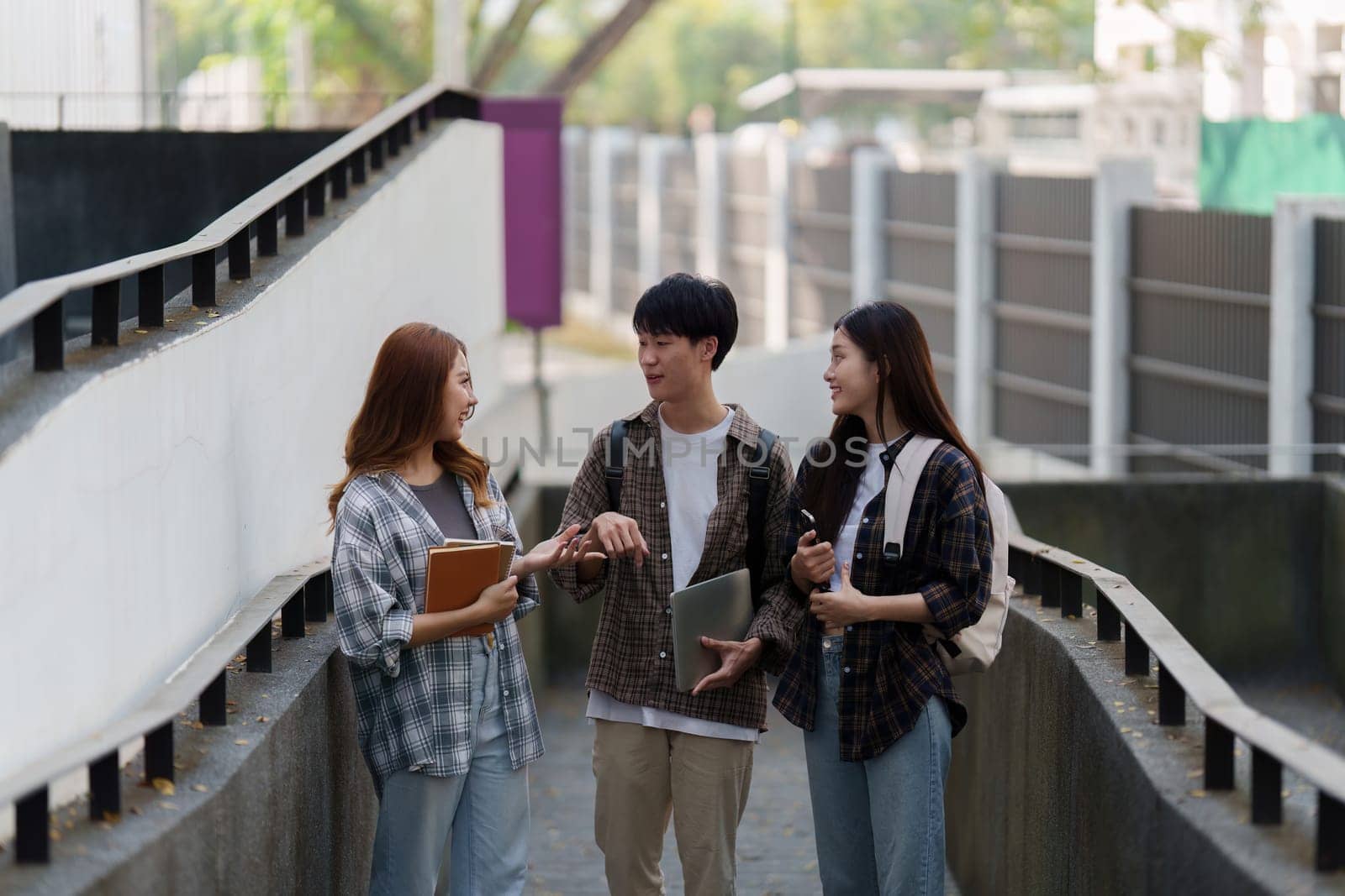 Young Asian woman college student with friends at outdoors. College student working on the college campus, education, school, study by itchaznong