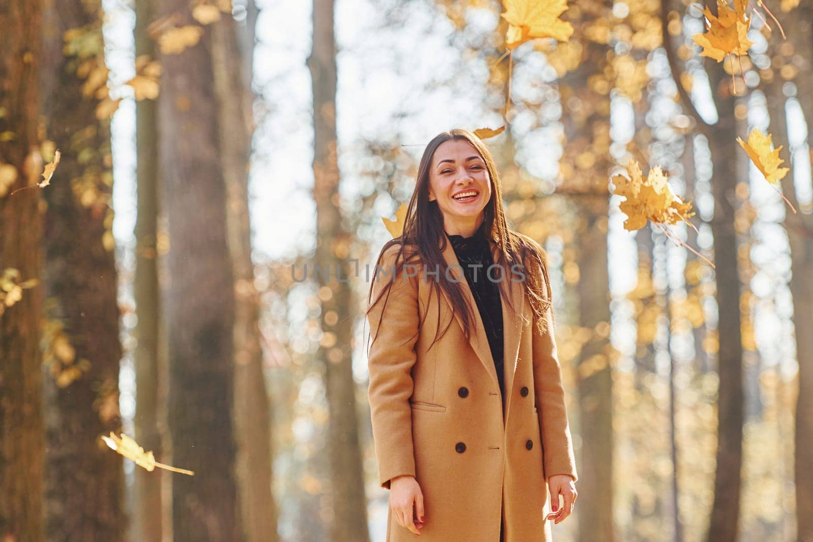 Having good mood. Woman in coat have walk in the autumn forest.