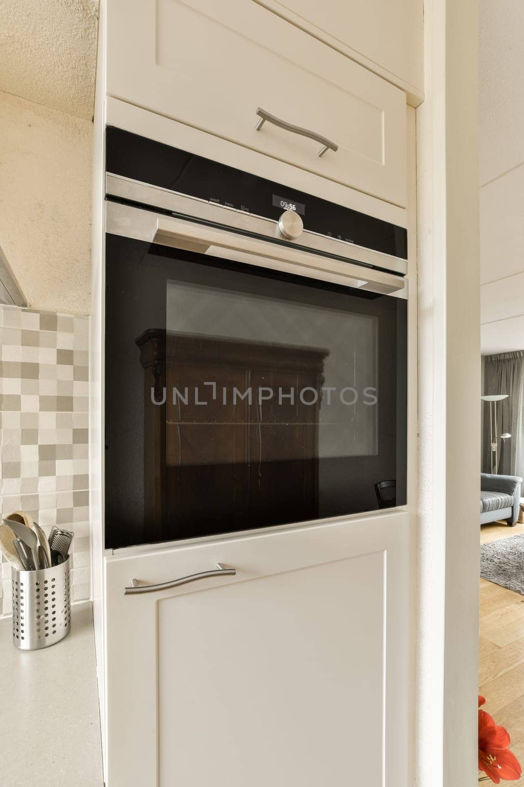 a kitchen with an oven on the wall and some uts in the cabinet door open to show how it is going