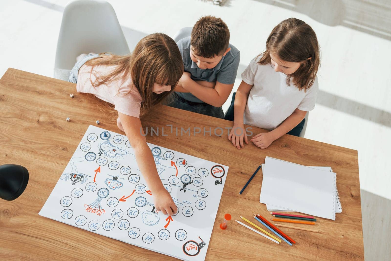Step by step game. Kids having fun in the domestic room at daytime together.